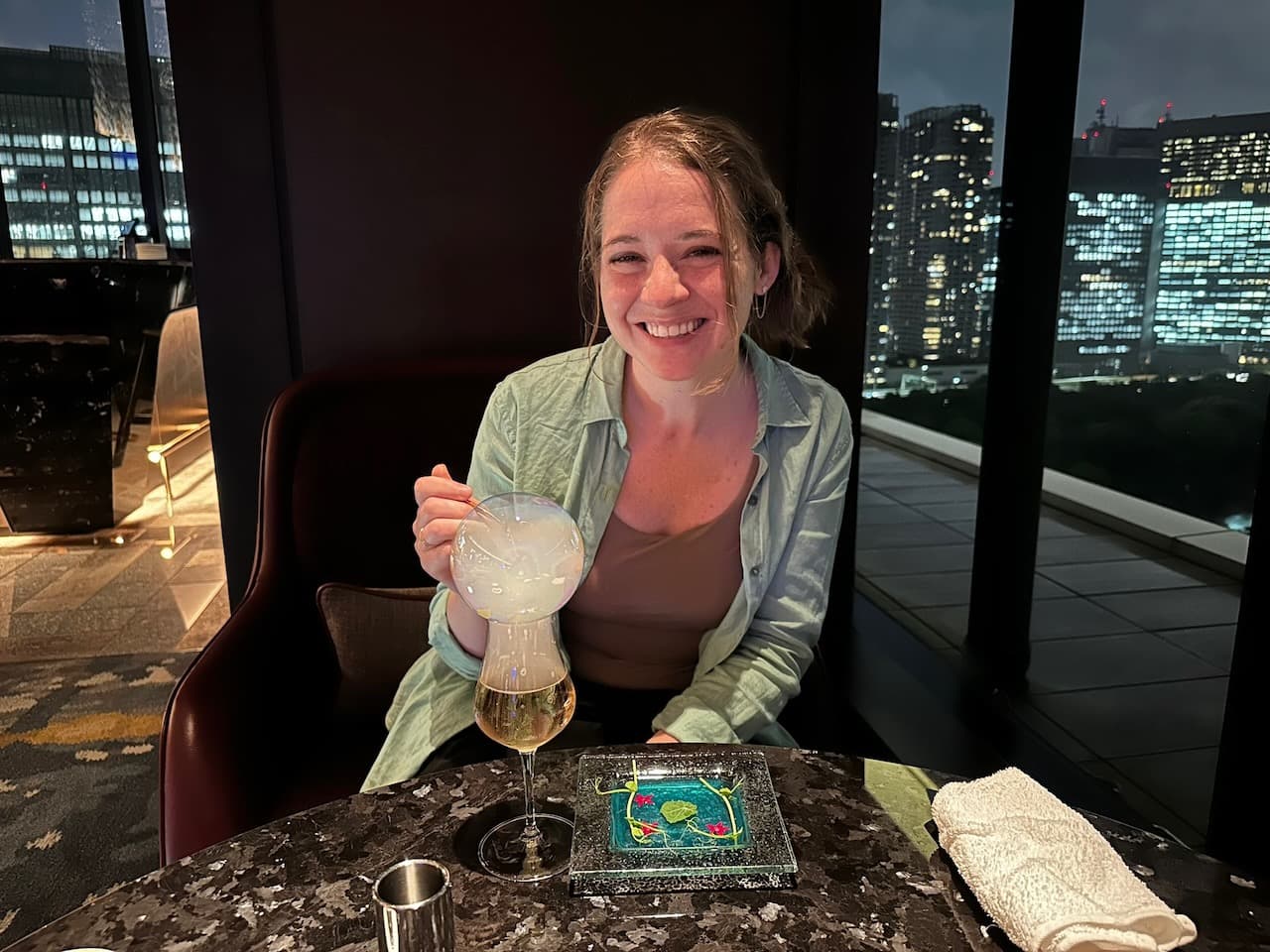 Madison with a "Suiren" cocktail at our hotel's bar, Whisk, inside the Mesm Tokyo